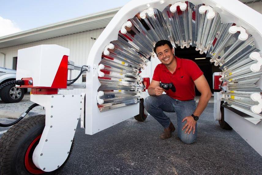 Doctoral candidate Rodrigo Borba Onofre works with robotic UV equipment for the University of Florida's Strawberry Lab near Tampa, Fla. Photo credit: UF-IFAS