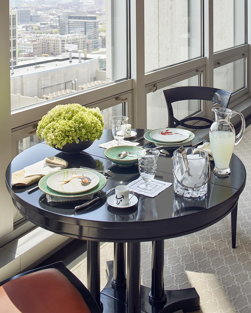 Vintage lacquered table and chairs upholstered in a Holly Hunt deep orange leather make an inviting place for breakfast. The table expands to seat 8 for dinner parties.