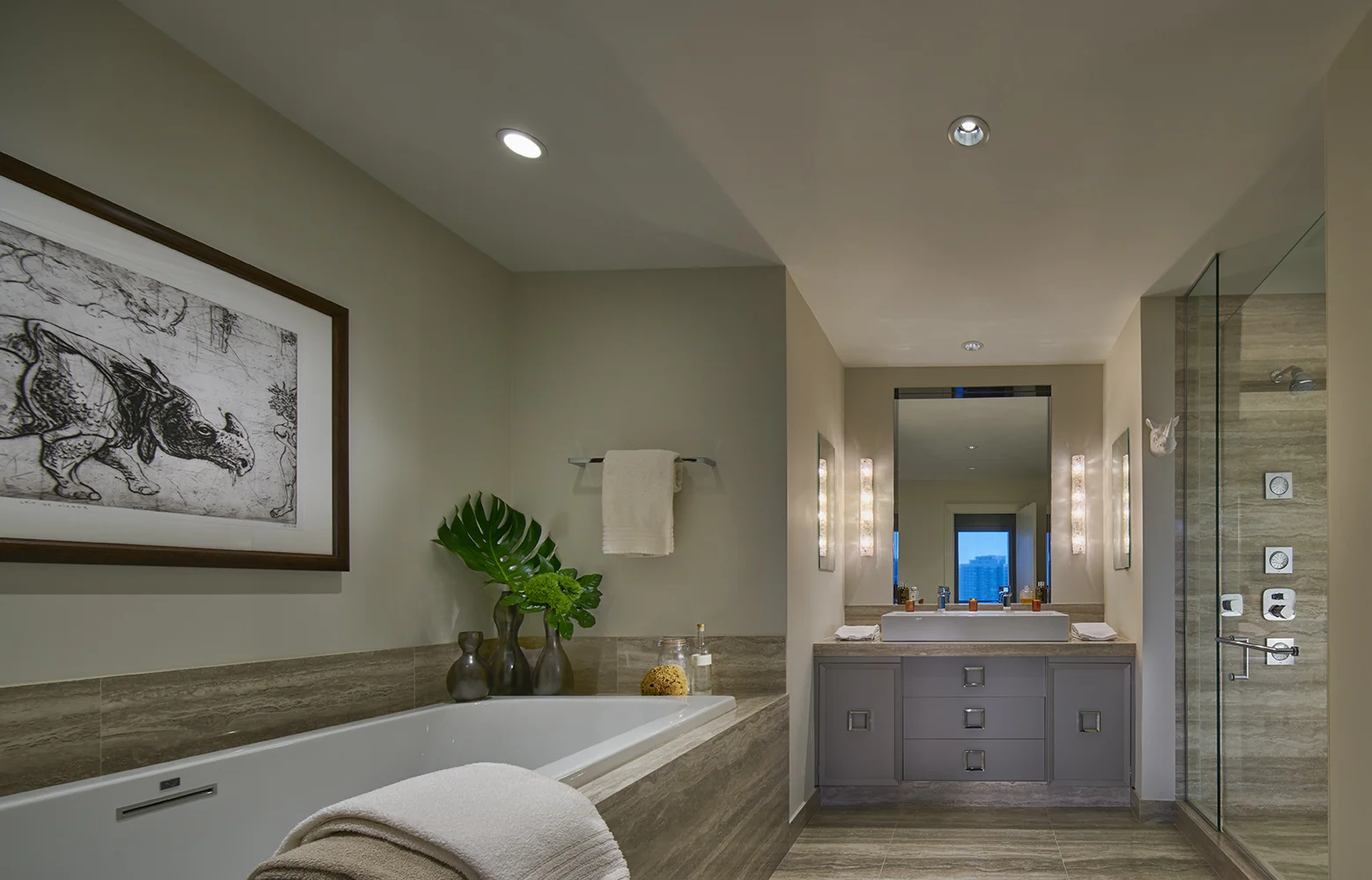 In His Bath, Travertine porcelain slabs from Portugal clad the walls, floor and counter. A vintage chest was lacquered and converted into the vanity.