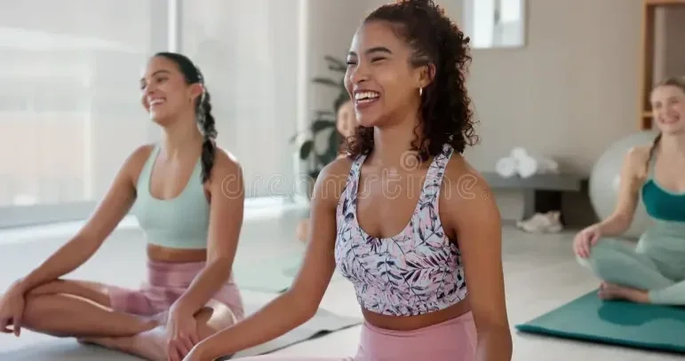 laughing-meditation-yoga-woman-friends-floor-studio-mental-health-mindfulness-wellness-funny-smile-zen-329008690.webp