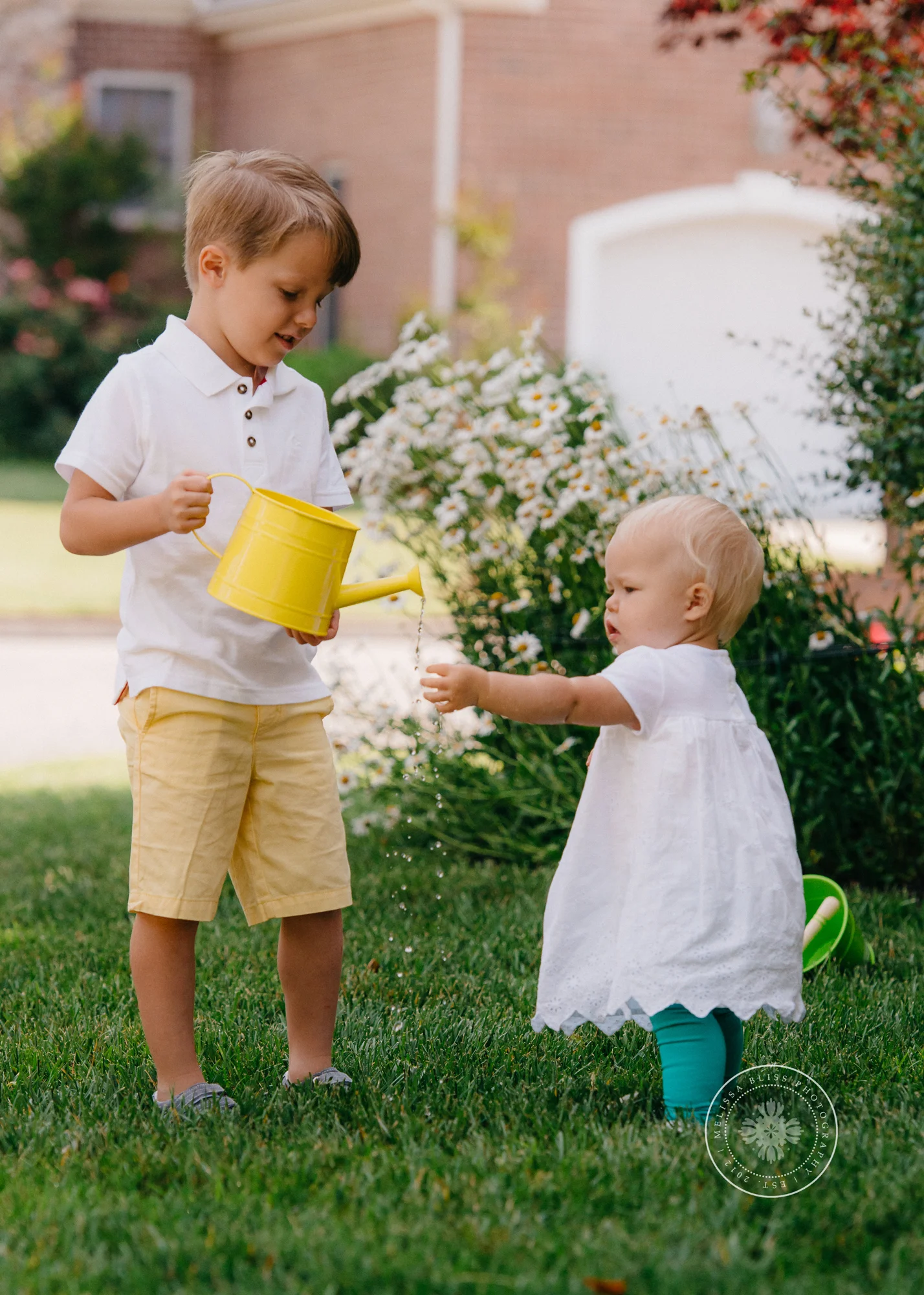 boy-and-girl-watering-spring-flowers-chesapeake-family-photographer-melissa-bliss-photography