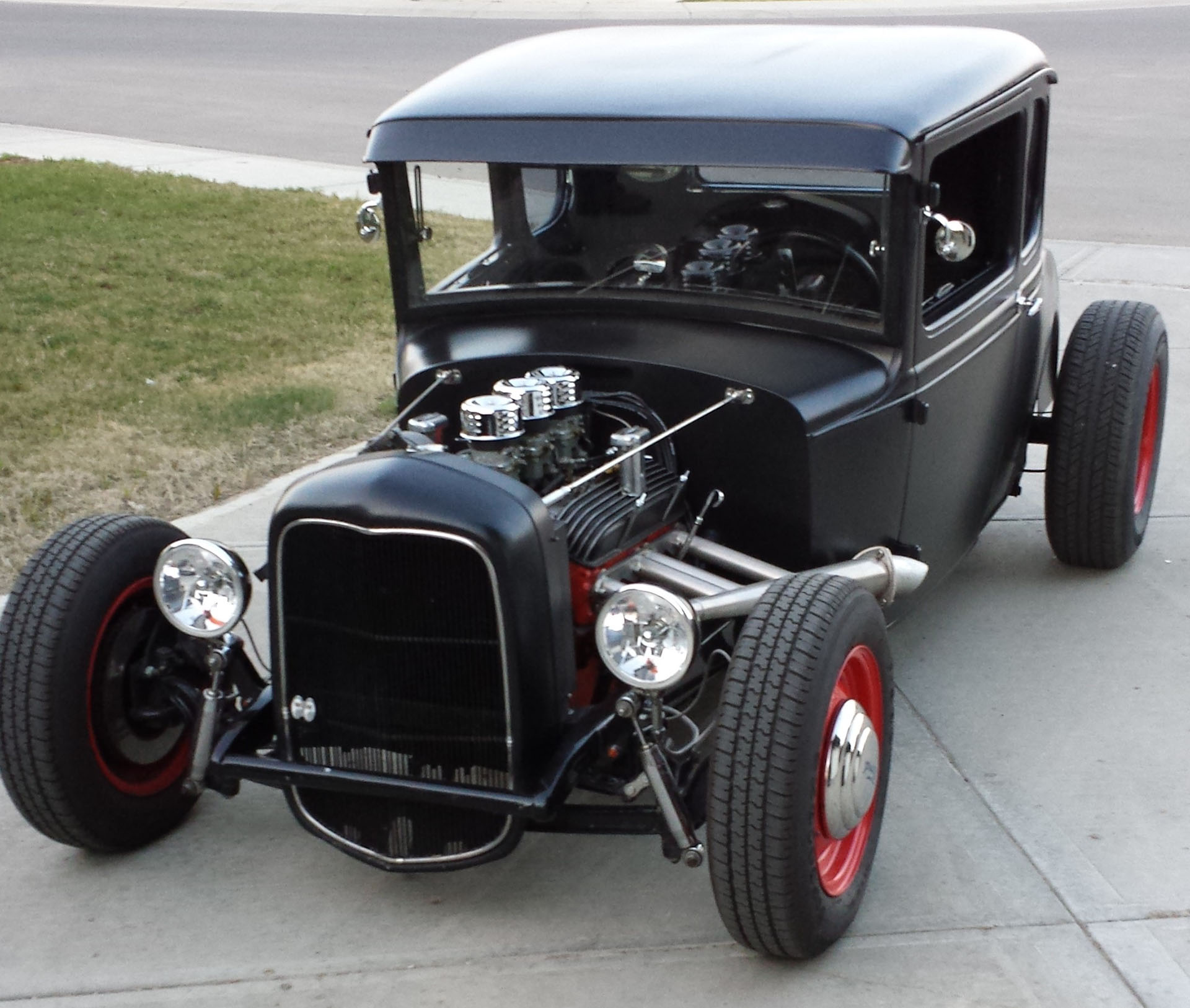 1931 Ford Model A Coupe Always had a thing for the hot rods, going as far back to when I as a farm kid with my little hot wheels collection. Guess that is what planted the seed back then and the passion only grew as a person got older. It was only a handful of years ago that my work afforded me the opportunity to purchase my own “full size” hot rod. It is a channelled satin black 1931 Ford Model A Coupe; some refer to it as a 5 window. It has a 283 Chevrolet engine, with a tri carb setup, 700 R4 auto transmission, to a Ford 9” rear. It rides on Firestone rubber with 15” steel wheels. It is a work in progress. I get a kick seeing other people enjoy it too.