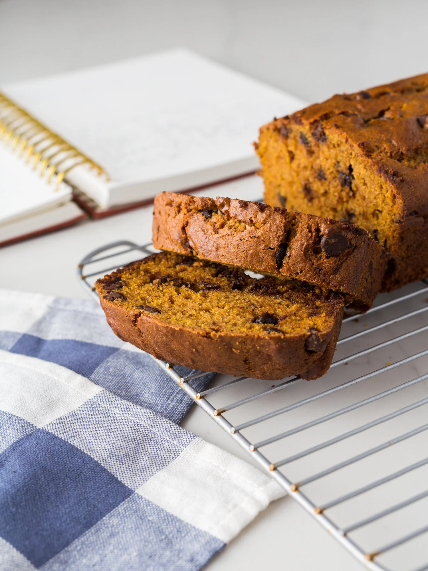 A loaf of Mel’s Perfect Pumpkin Chocolate Chip Bread with the recipe written in a Golden Coil Planner