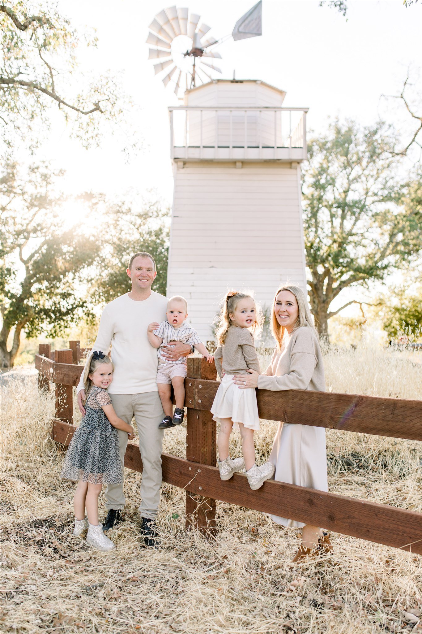 Family photos at golden hour in front of windmill at Walnut Creek park