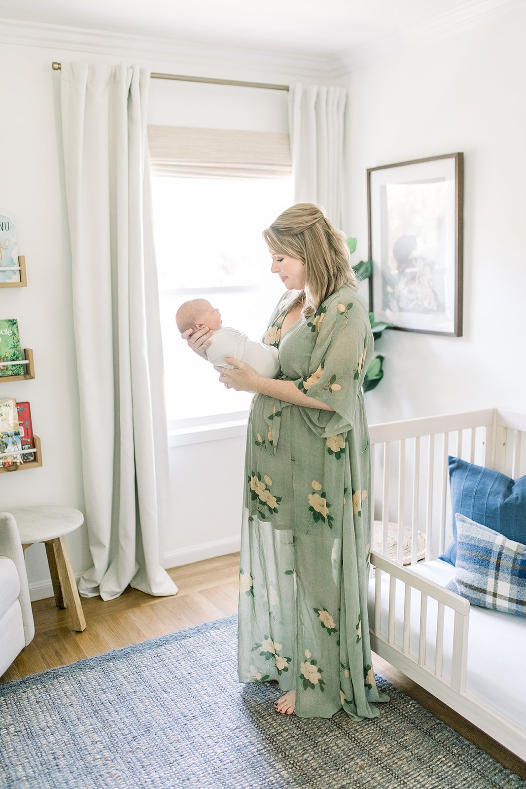 Mom holds newborn son in nursery