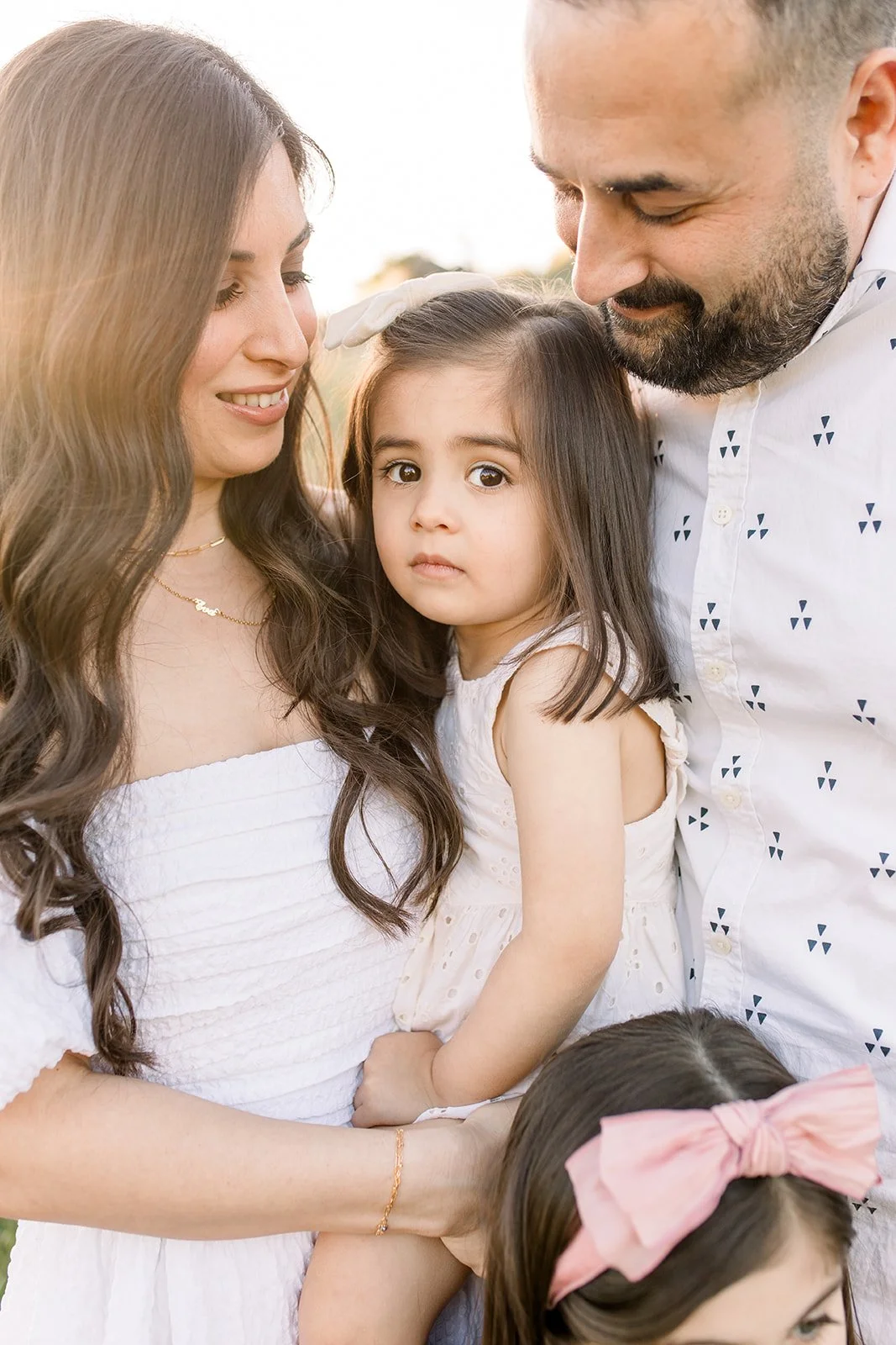 Family of four snuggle into their youngest child