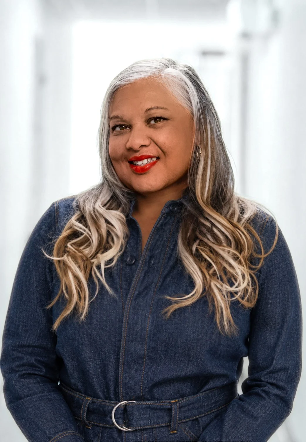Lori Lockemy smiling in a dark denim outfit