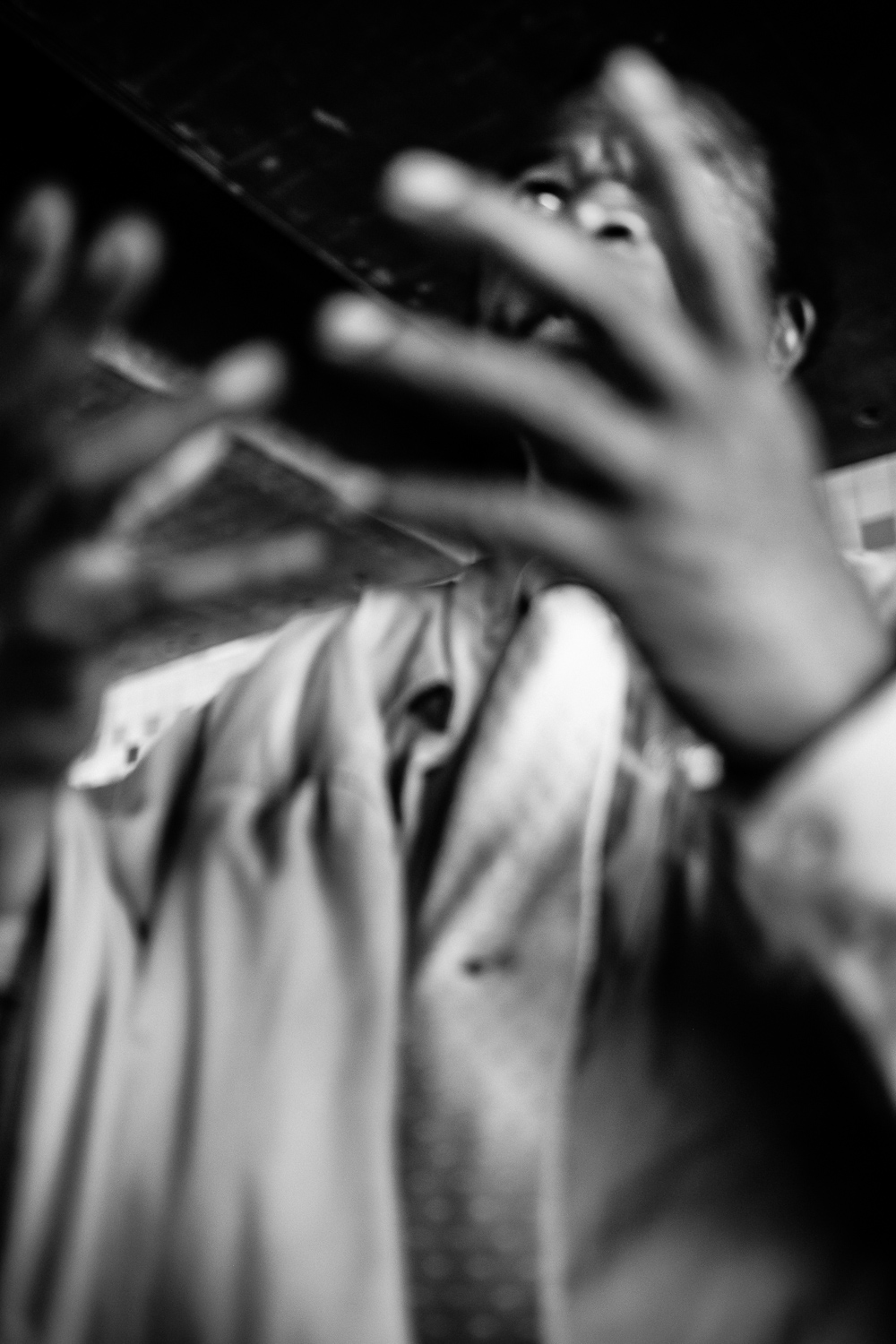 Moment One: Here, taken from below and with his hands raised as they are, to me, conveys a sense of urgency. The lower perspective may carry with it unconscious memories of being a kid and feeling like whatever the adults are talking about is above my pay grade. Plus, the blur can make one feel, literally, like there's a lack of clarity about the scene. The hands are almost indicating a plea. What might he be saying? "Please!" or "Why?!" That's for me to know and you to imagine.