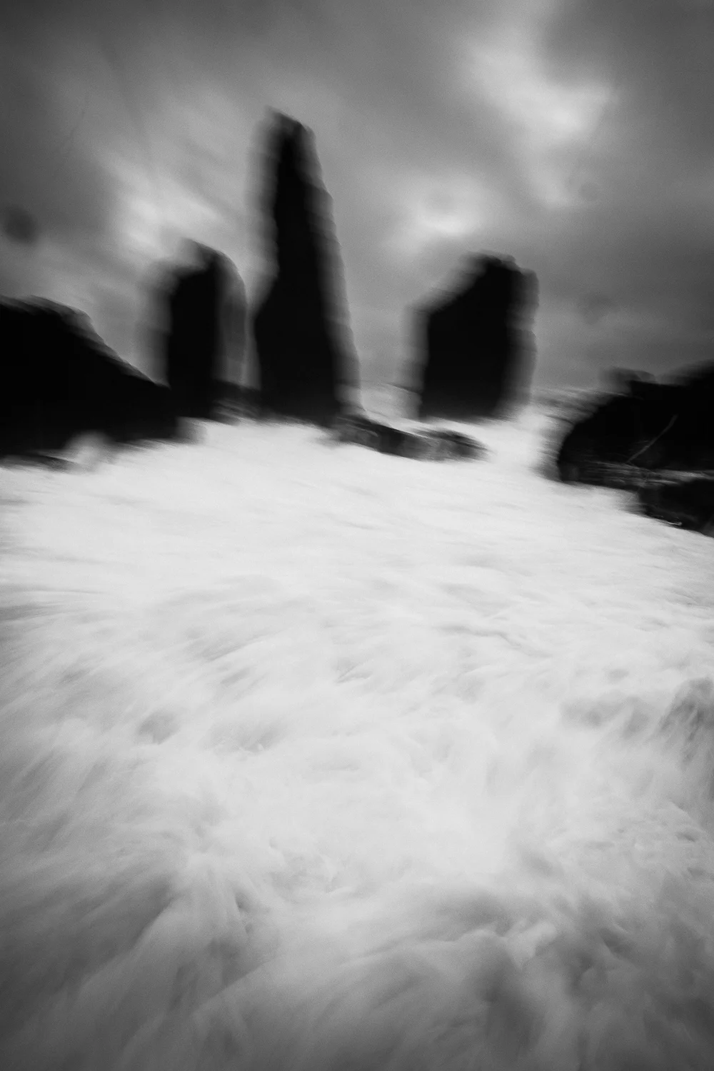 Here’s a picture worth a thousand words pertaining to my experience of Icelandic weather. Firstly, in the sky area, look at all that gunk! Blobs on the sensor, mist on my polarizer, and who knows what that streak is?! Secondly, does it look like I’m about to get swamped with a heavy dose of sea water? Well, I did. I was in shooting mode and barely escaped with my Fuji intact as a blast of whitewash hit the rocks before me and splashed up. That’s why there’s blur…the shutter was released as the tripod was being lifted. My whole front side was soaked, my Wellies were now half full of water, and the X-T2 was uncomfortably drenched with salty moisture. First things first: get the battery out of the X-T2 and dry it off. Now, shoot more!