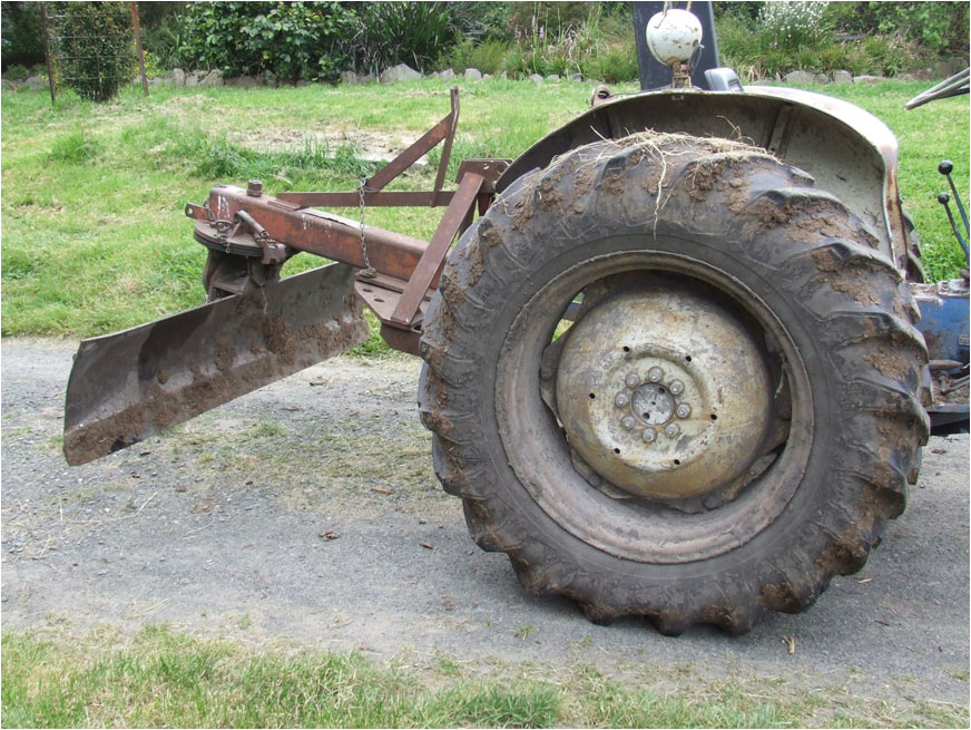 Blade on back of tractor used for scalping site