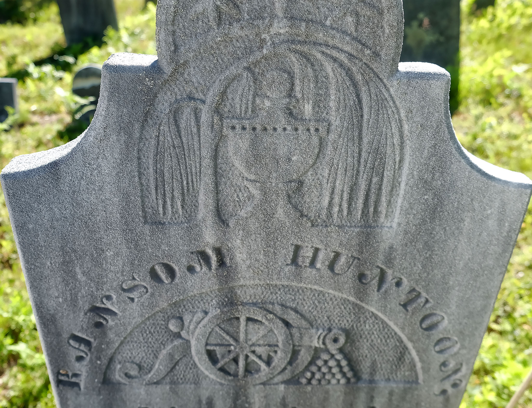 Detail of the weeping willow and urn on the tympanum. Photo by Author. 