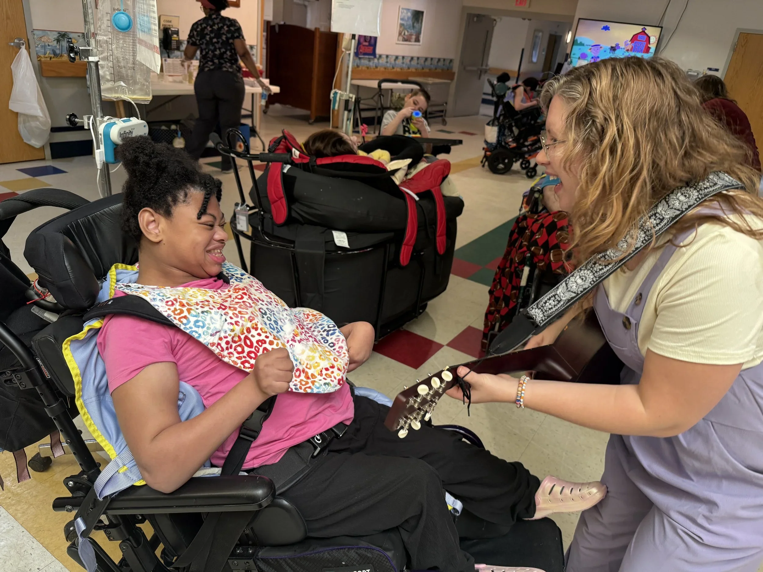  Resident Ana smiles during music therapy in her temporary home. 