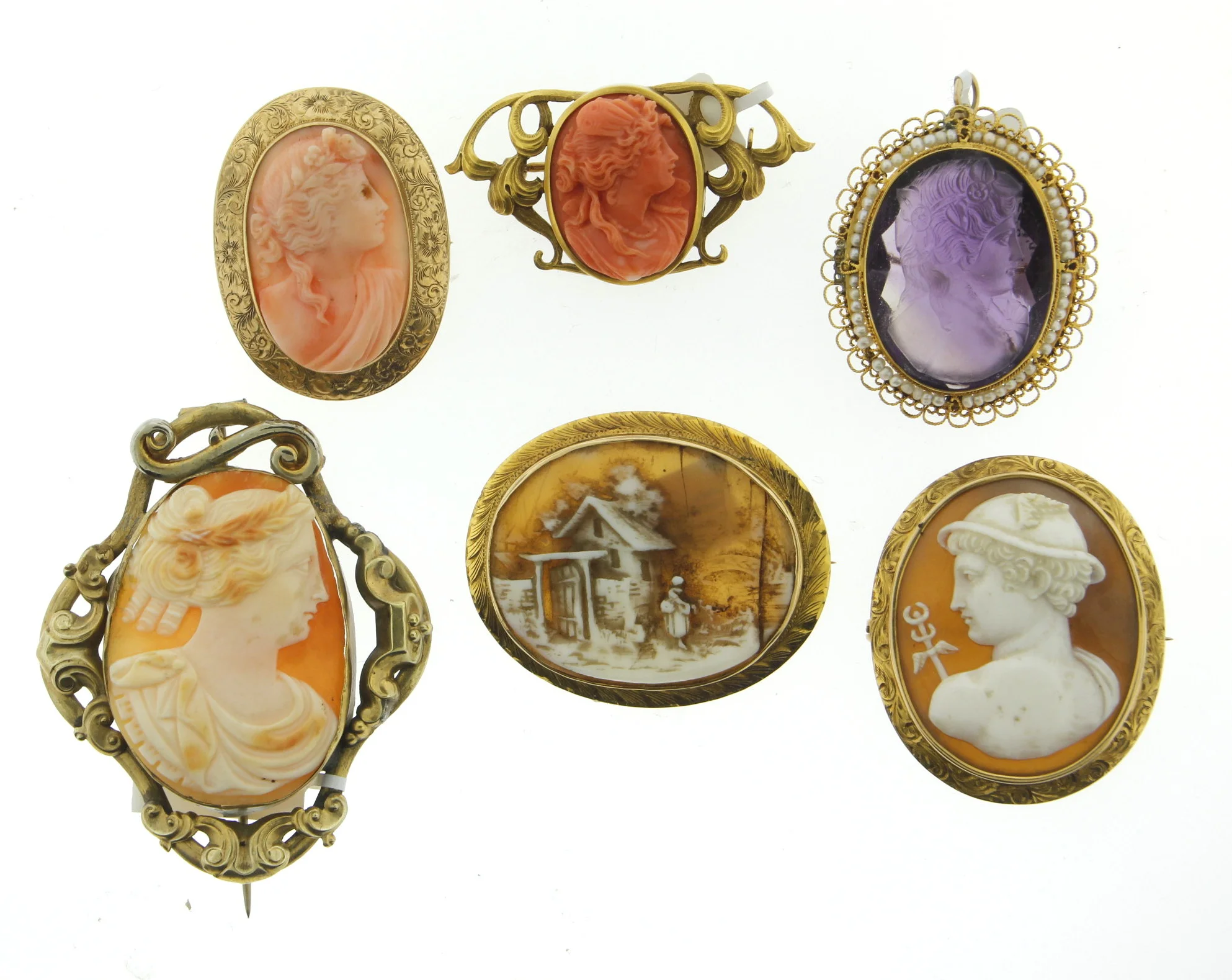 Large cameo on the lower left is likely the oldest. Made in gold fill with a pin that extends past the brooch and does not have a safety. The coral cameo upper middle appears to be from the Art Nouveau period based on the scroll work and symmetry of the mounting.