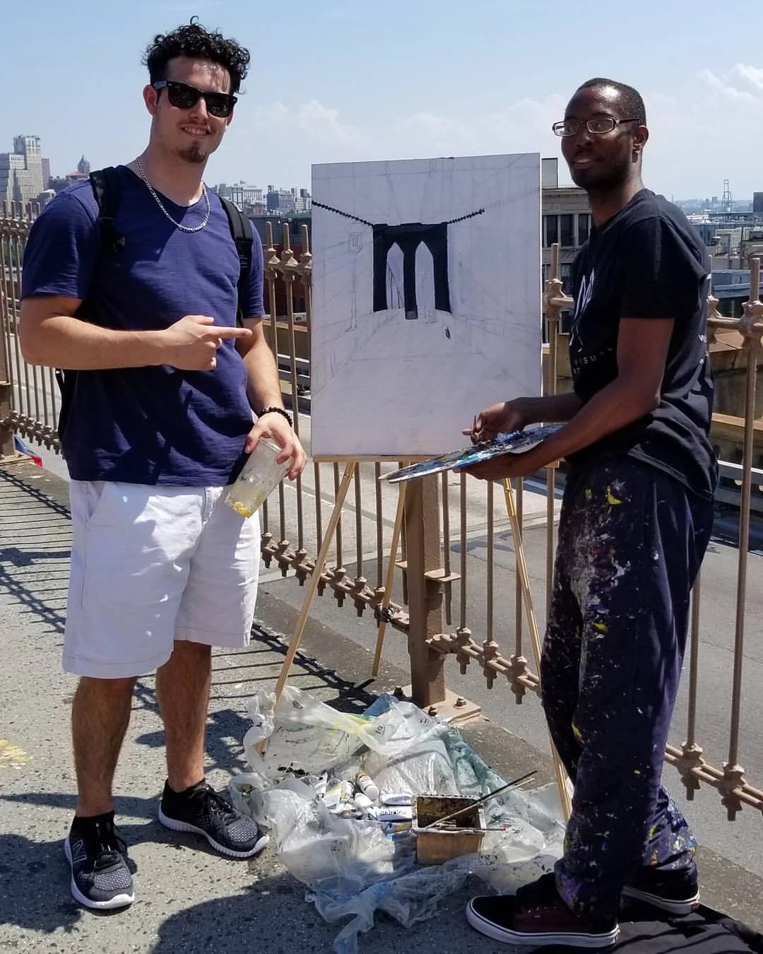 Me (on the right) and a tourist I met on the Brooklyn Bridge took a photo with me along my artwork. That I was live painting of the bridge walkway. 