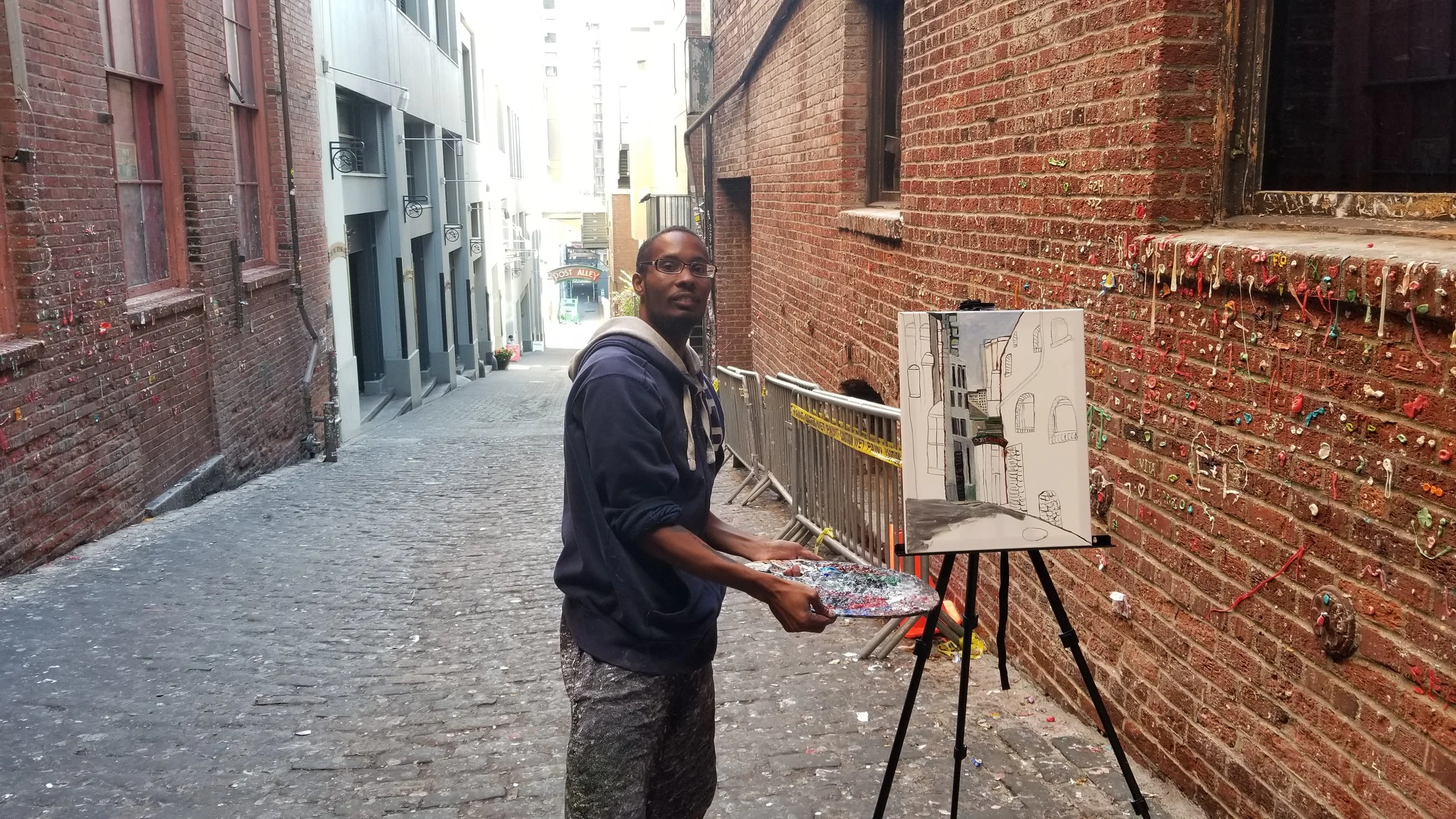 Me working on the live en plein air painting of the Post Alley at the pike place market Gum Wall.