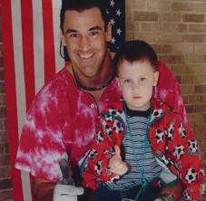 Mike Utley thumbs up with child - recognition dontation
