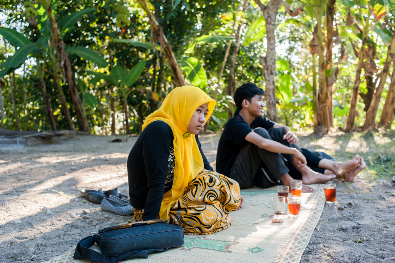 Zuna gazes off towards her friends playing with traditional Javanese masks in the village of Kepuhan.