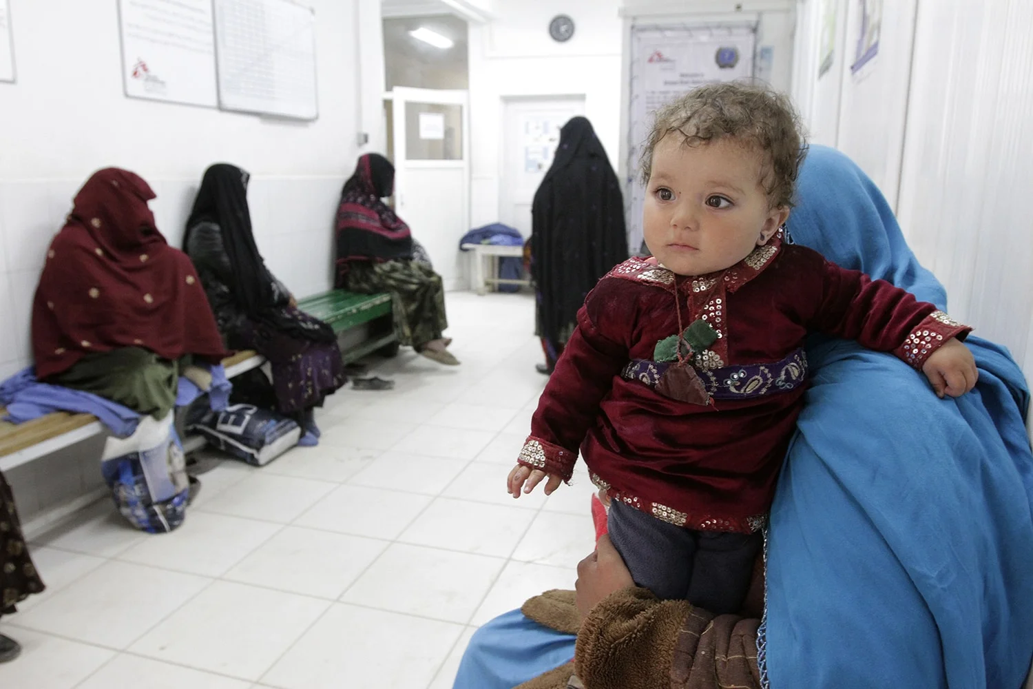 Relatives wait outside the delivery rooms at Ahmad Shah Baba District Hospital in Kabul, Afghanistan on Feb. 24. 2014. (AP Photo/Cassandra Vinograd)