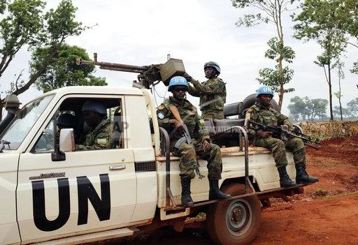 In this photo taken Friday May 26, 2017, UN peacekeepers patrol outside Bria, Central African Republic. The United Nations says about 300 people have been killed and 200 wounded in the past two weeks alone in Bria and a handful of other towns. The U.N. humanitarian agency said the unprecedented violence emptied Bria of its population, sending an “uninterrupted stream” of residents toward makeshift camps. (AP Photo/Cassandra Vinograd)