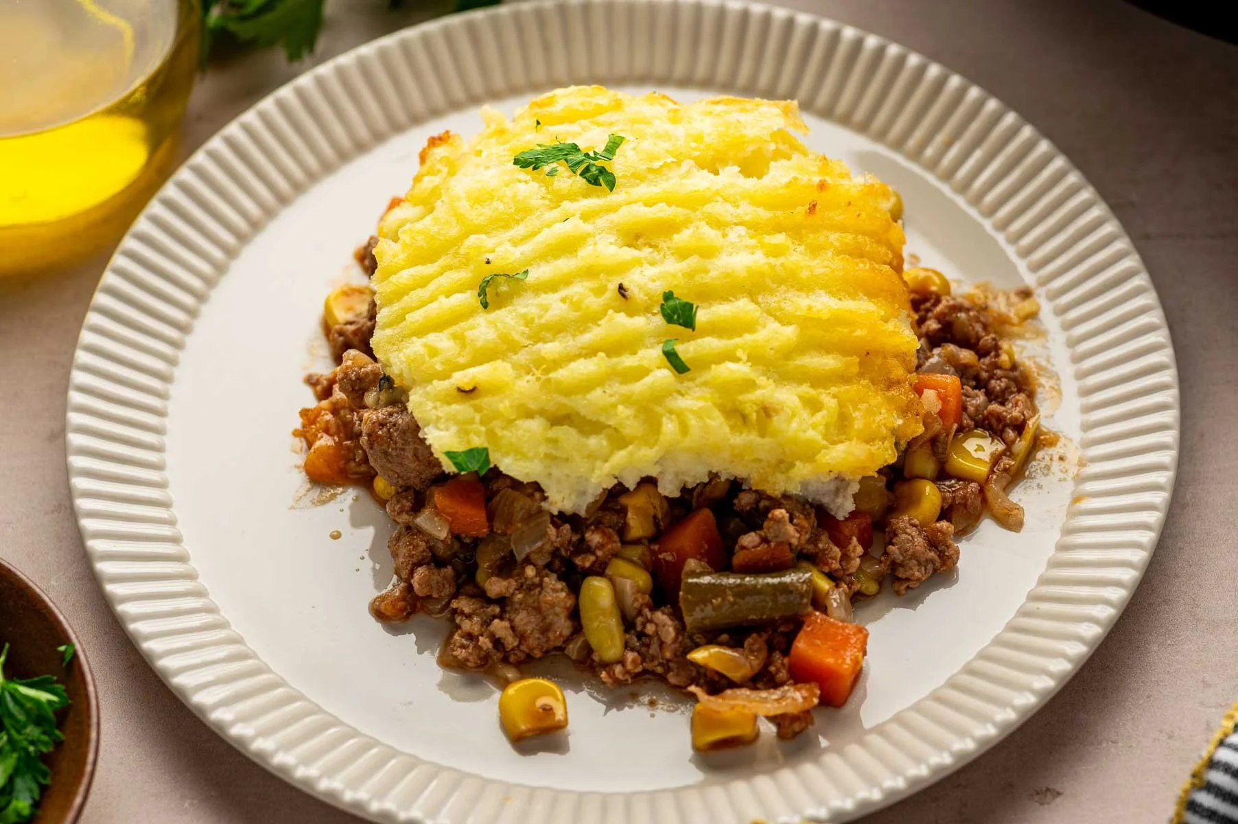 A slice of shepherd's pie on a white plate