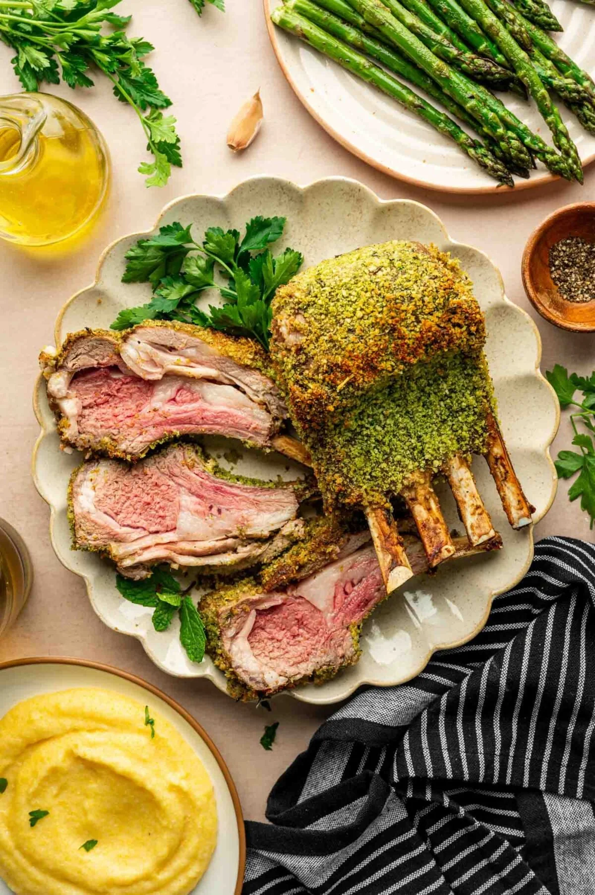 Herb-crusted rack of lamb on a plate with fresh parsley.