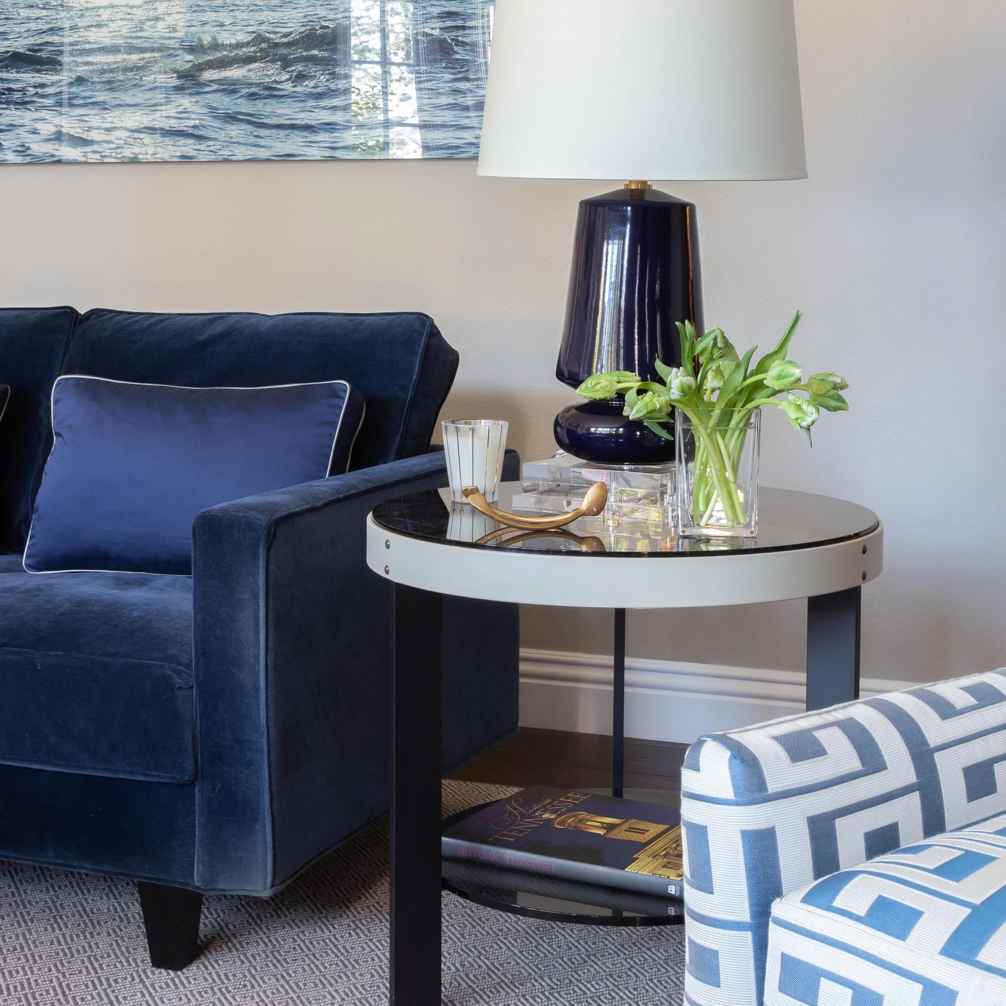 Colorful lamps and furniture such as this leather and smoked glass side table create interest and beauty like in this contemporary formal living room.