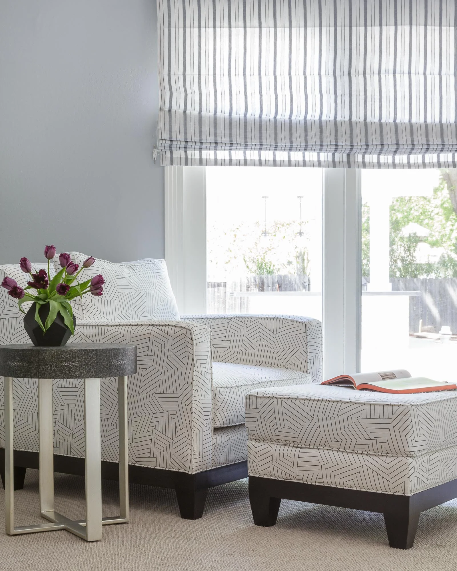 Master Bedroom lounge chair upholstered with Schumacher fabric aside a grey faux shagreen side table