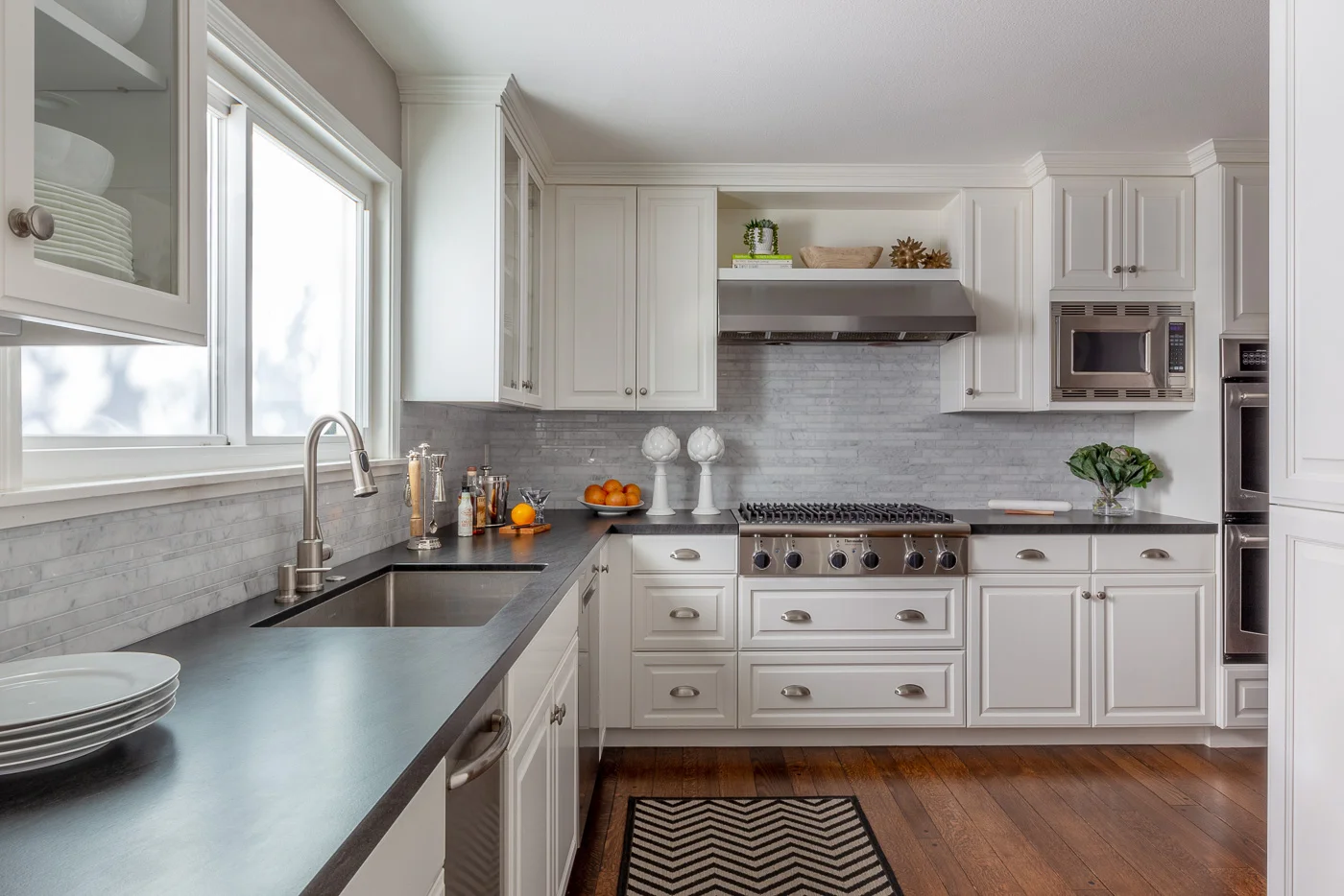 Danville, CA transitional kitchen with white cabinetry, Basaltina counter and a random strip Carrara backsplash