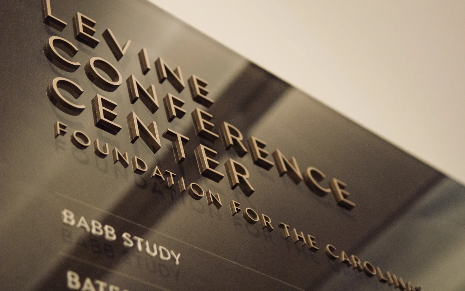  A rich palette of dark bronze, copper, and pale gold reinforces the commemorative nature of the building, where rooms and amenities are named after Foundation donors and honorees. An element of dimensionality adds interest and a sense of permanence 