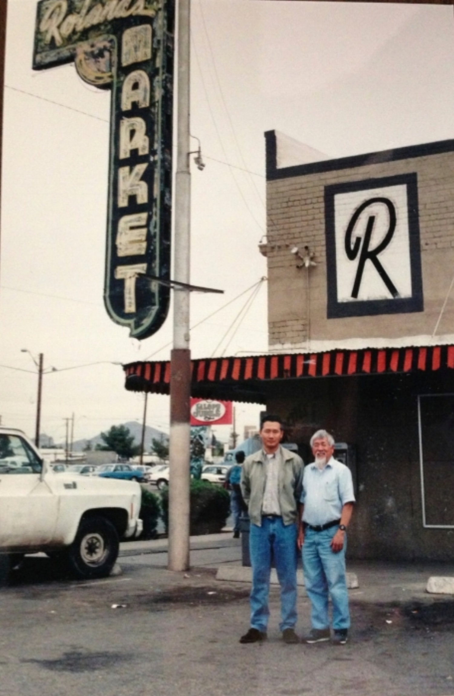 Kai with the Korean grocer that bought Roland's Market in the 1980's