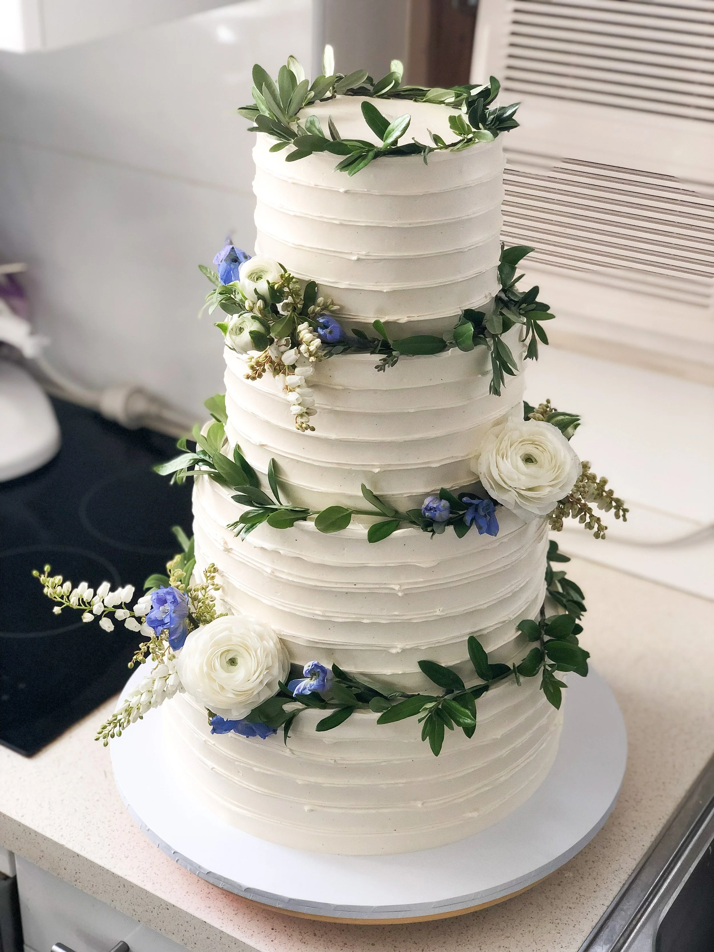 Four tier whipped finish with olive branch garlands