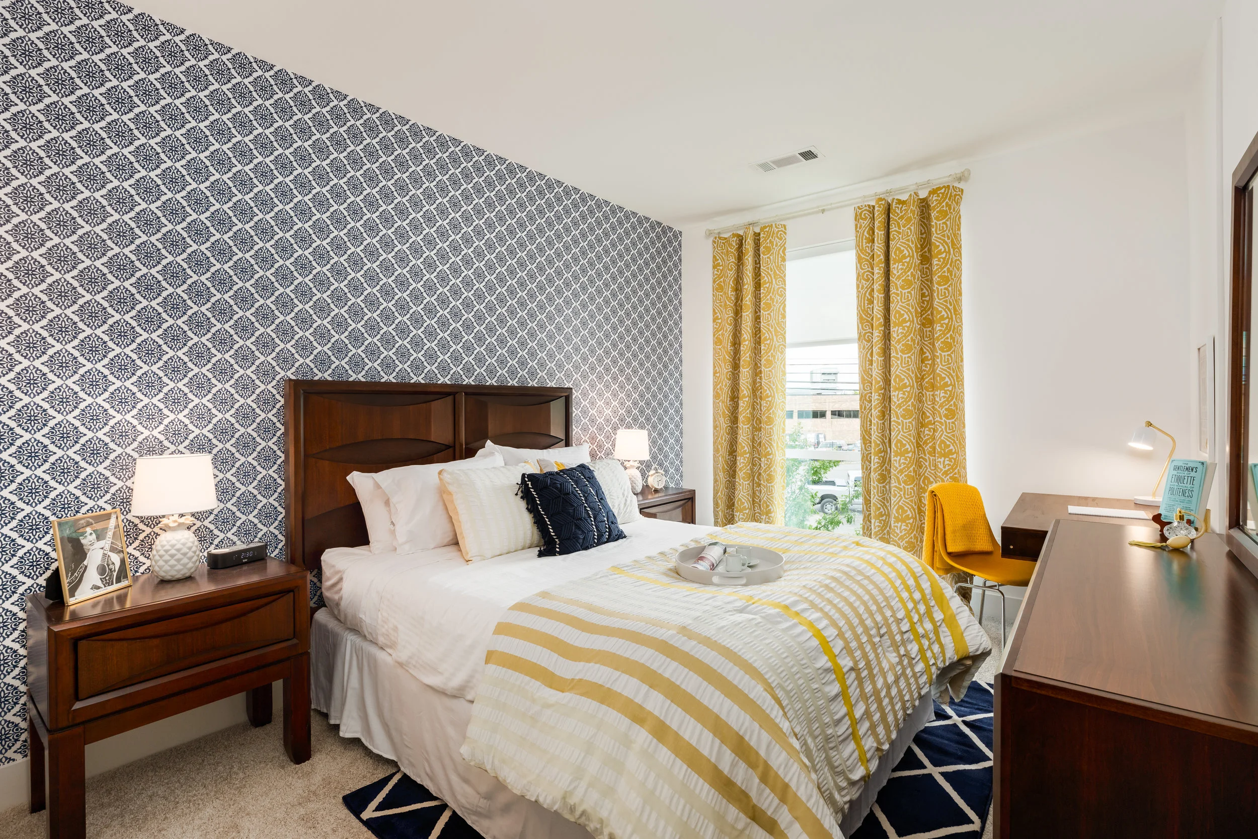 This room was inspired by Loretta Lynn. I had the opportunity to visit her ranch and see her beautiful dresses and life long doll collection. Yellow and blue fill this room with gorgeous curtains, wallpaper, and accents. Loretta is right there on th