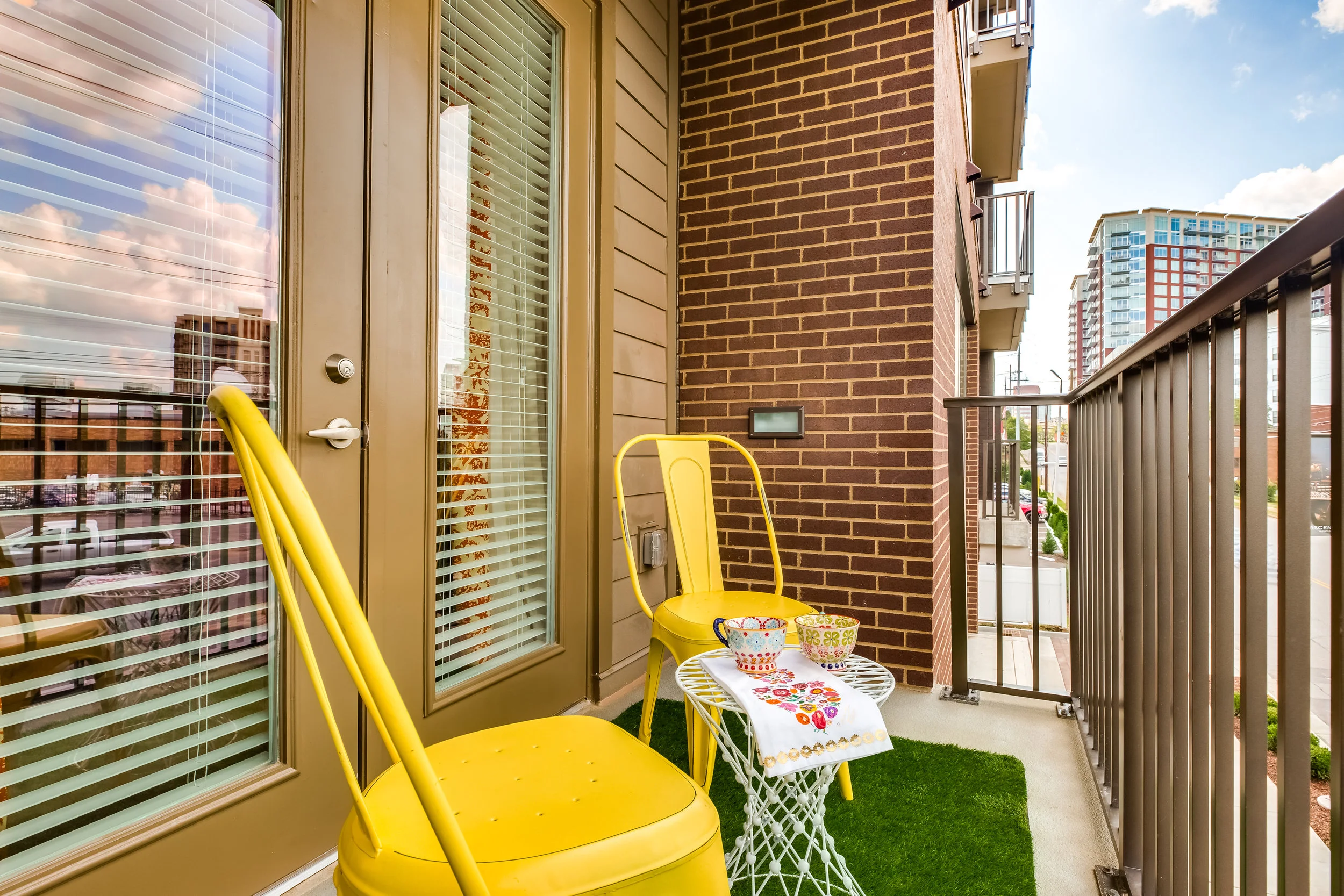 Nothing says Mid-Century Design like a green grass rug and some yellow chairs. The perfect set up for some coffee or tea in the morning.