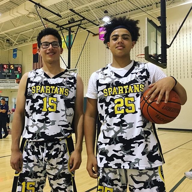 Black white and yellow basketball jerseys and shorts