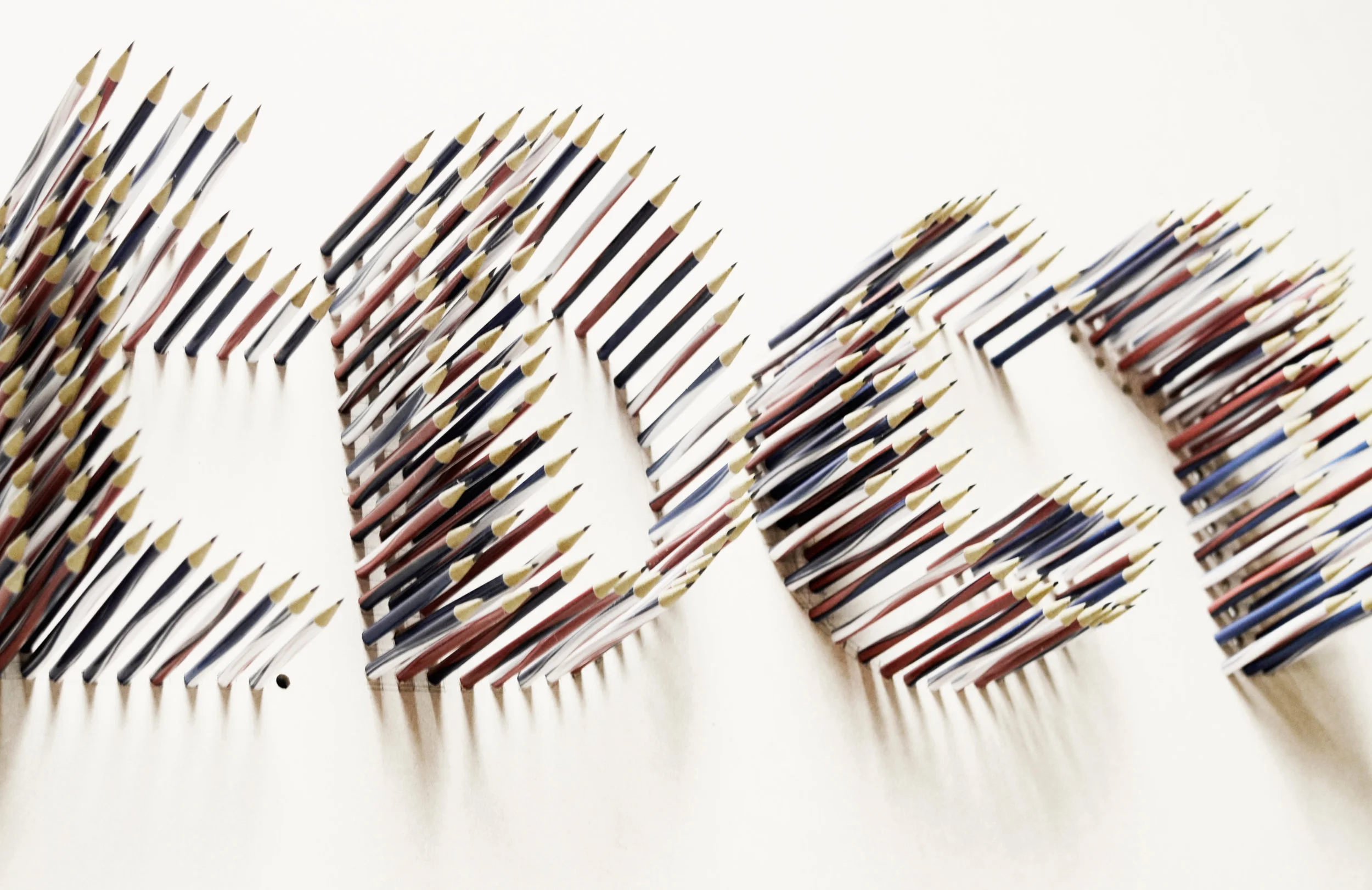 The Art Deco poster with 200 pencils drilled in cardboard. 