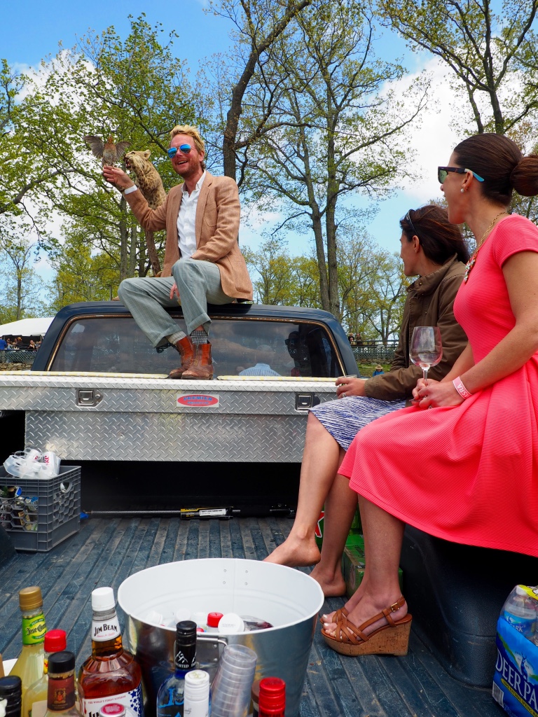 Enjoying a cocktail and a laugh at a race day tailgate. Watch out for the bobcat!