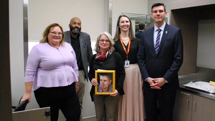 Alberta Health Minister Sarah Hoffman, left, MLA David Shepherd, Moms Stop the Harm co-founder Petra Schulz, Dr. Kathryn Dong of the Royal Alexandra Hospital (RAH) and Edmonton Mayor Don Iveson open the RAH’s Supervised Consumption Service, the first hospital-based service of its kind in North America. Schulz holds a portrait of her son Danny, who died of an accidental Fentanyl overdose in 2014. Photo by AHS. 