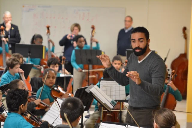 Josue leads an ensemble during practice time.
