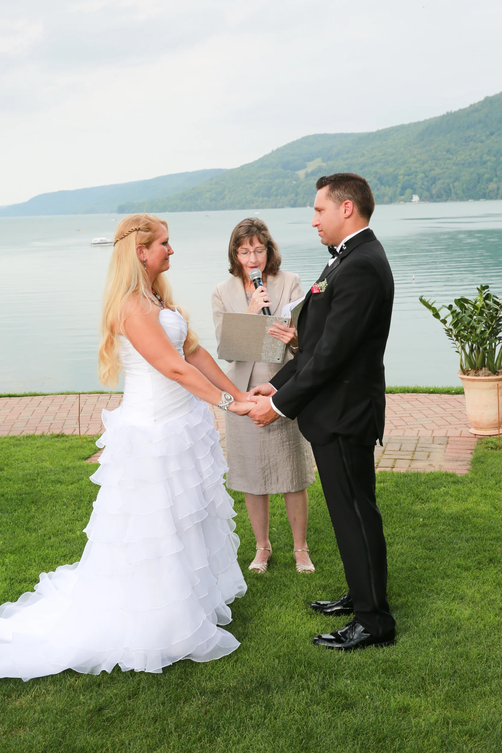 photograph of wedding vows at a lake side summer wedding.