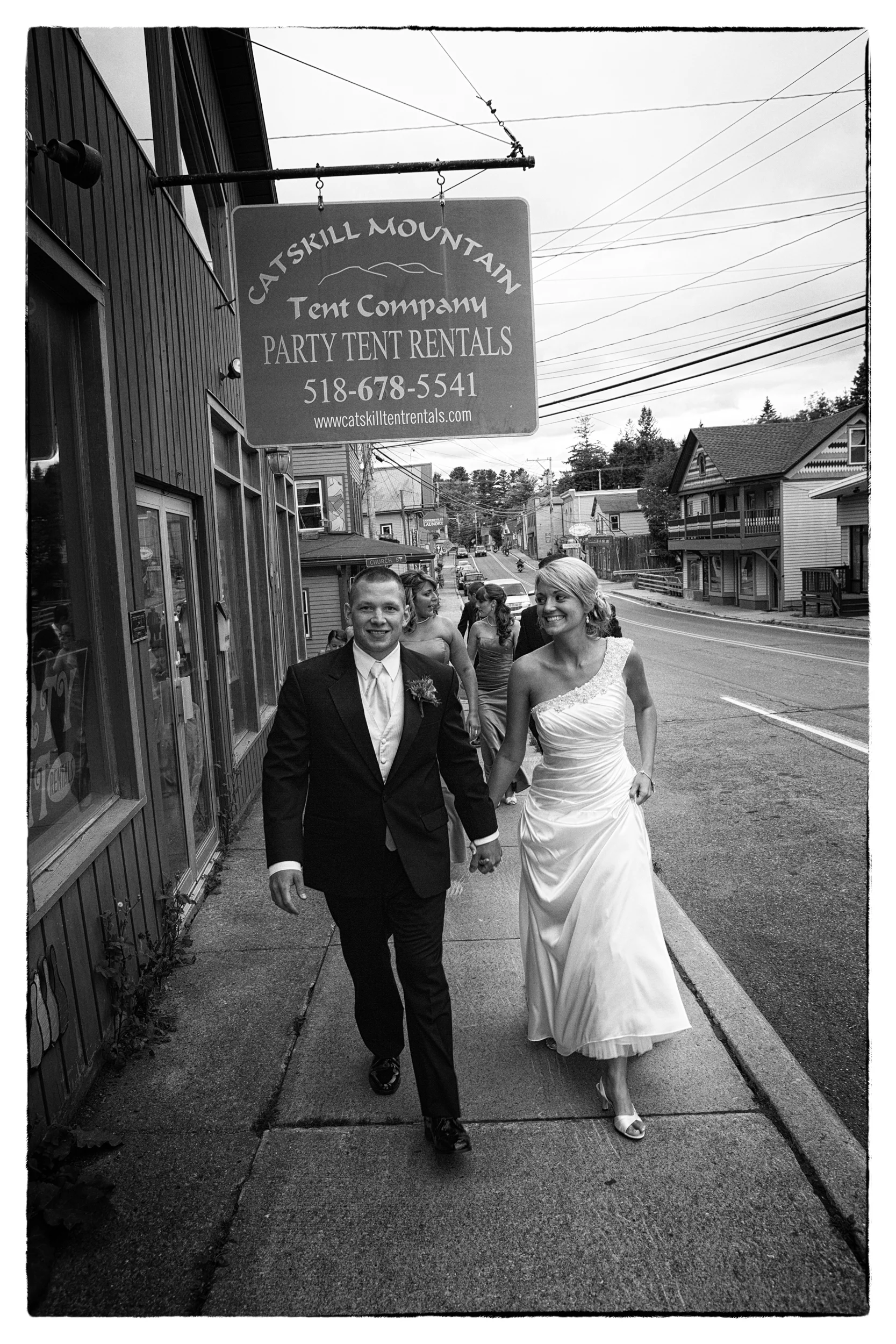 Bride and groom walking the streets of Hunter, NY