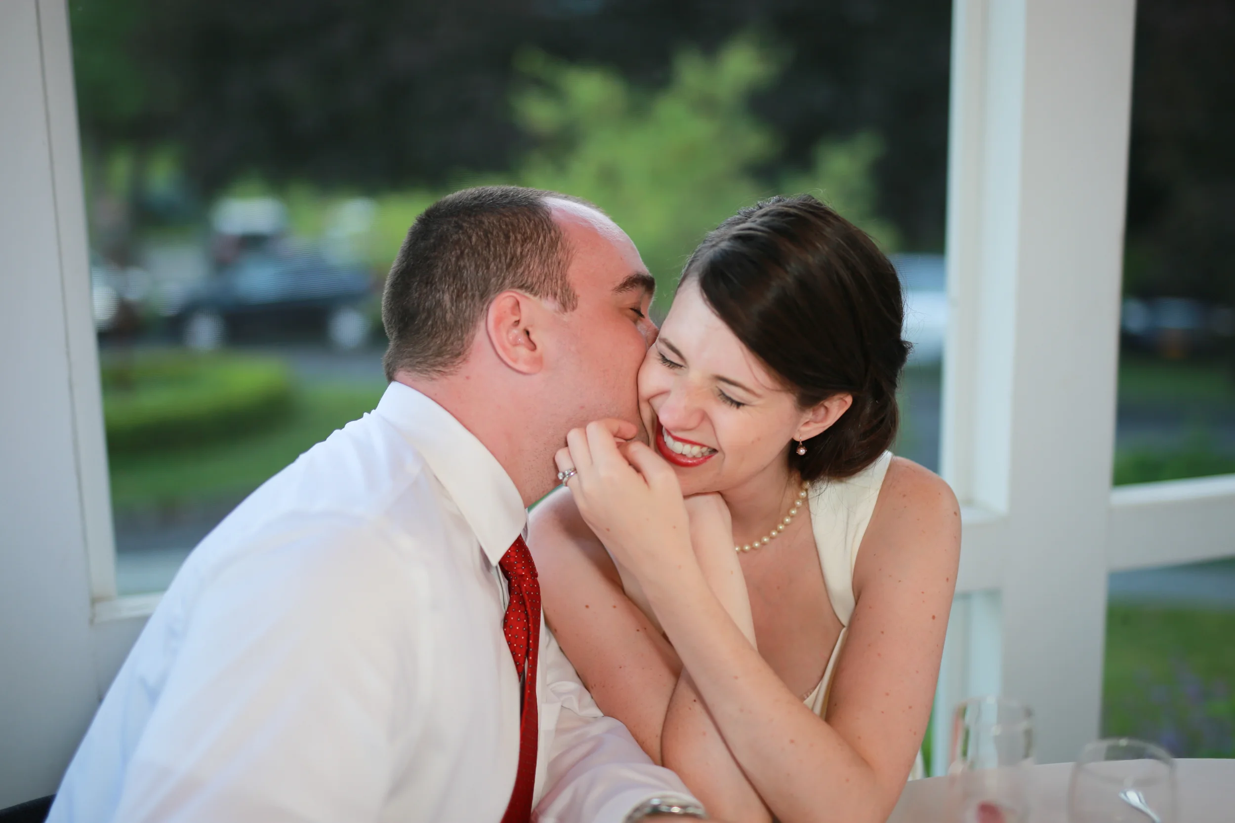 Bride and groom sharing a laugh at there wedding