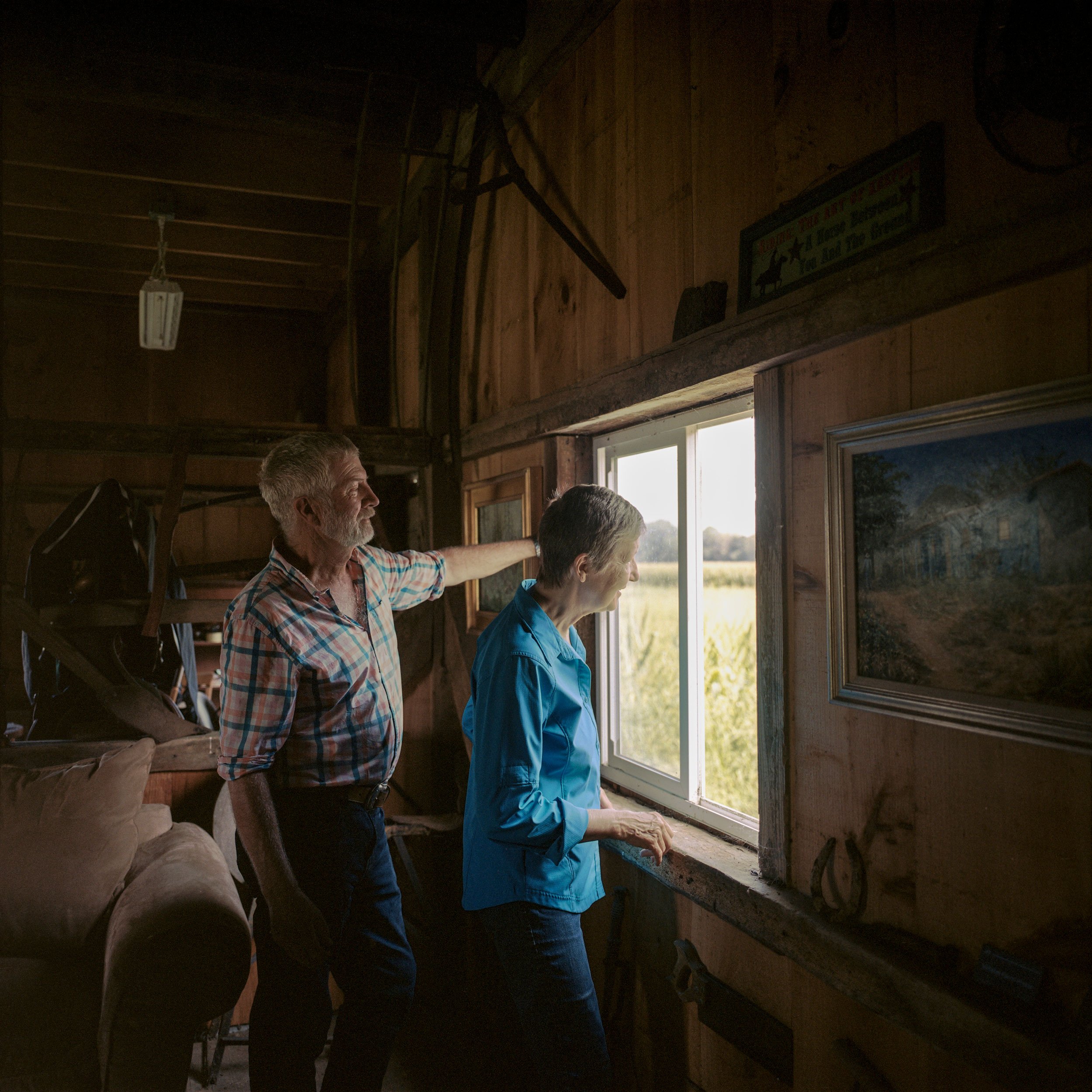 Jon Shaw and Anne Haberton look at the fields from the old grain house turned artist studio