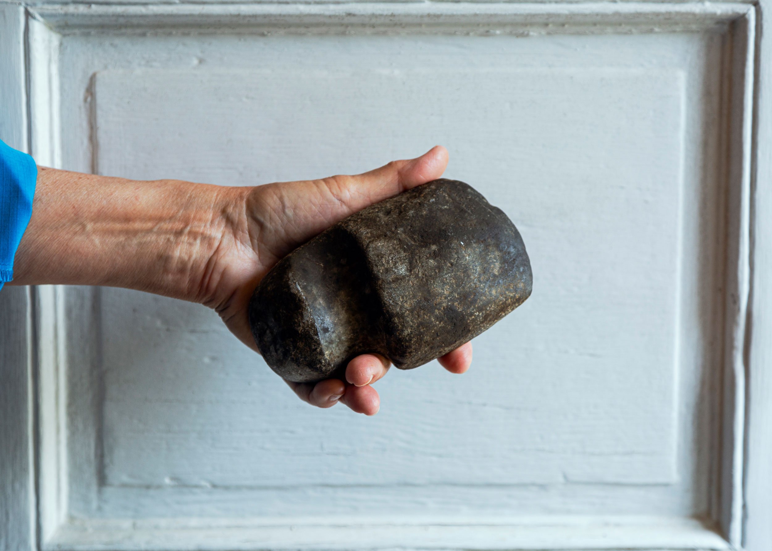 Ann holds a native axe head found on the farm. The farm has a Nanticoke Land Acknowledgement