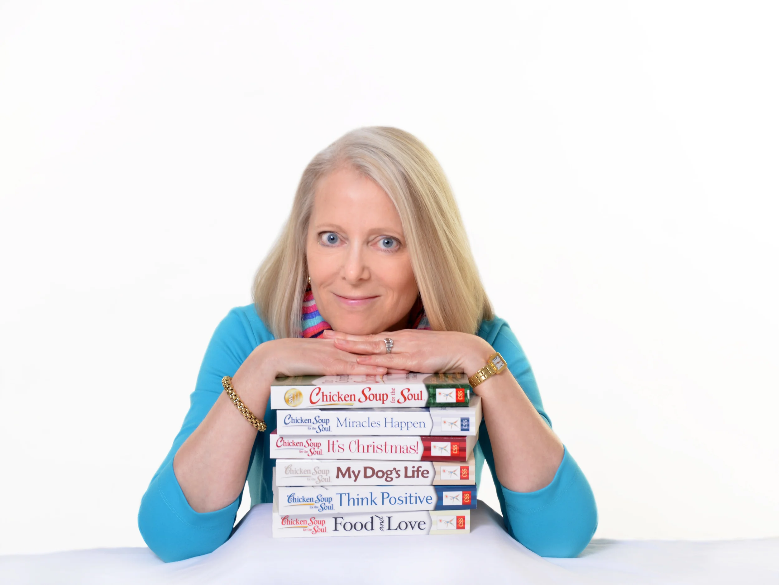 Amy Newmark leaning on stack of books.jpg
