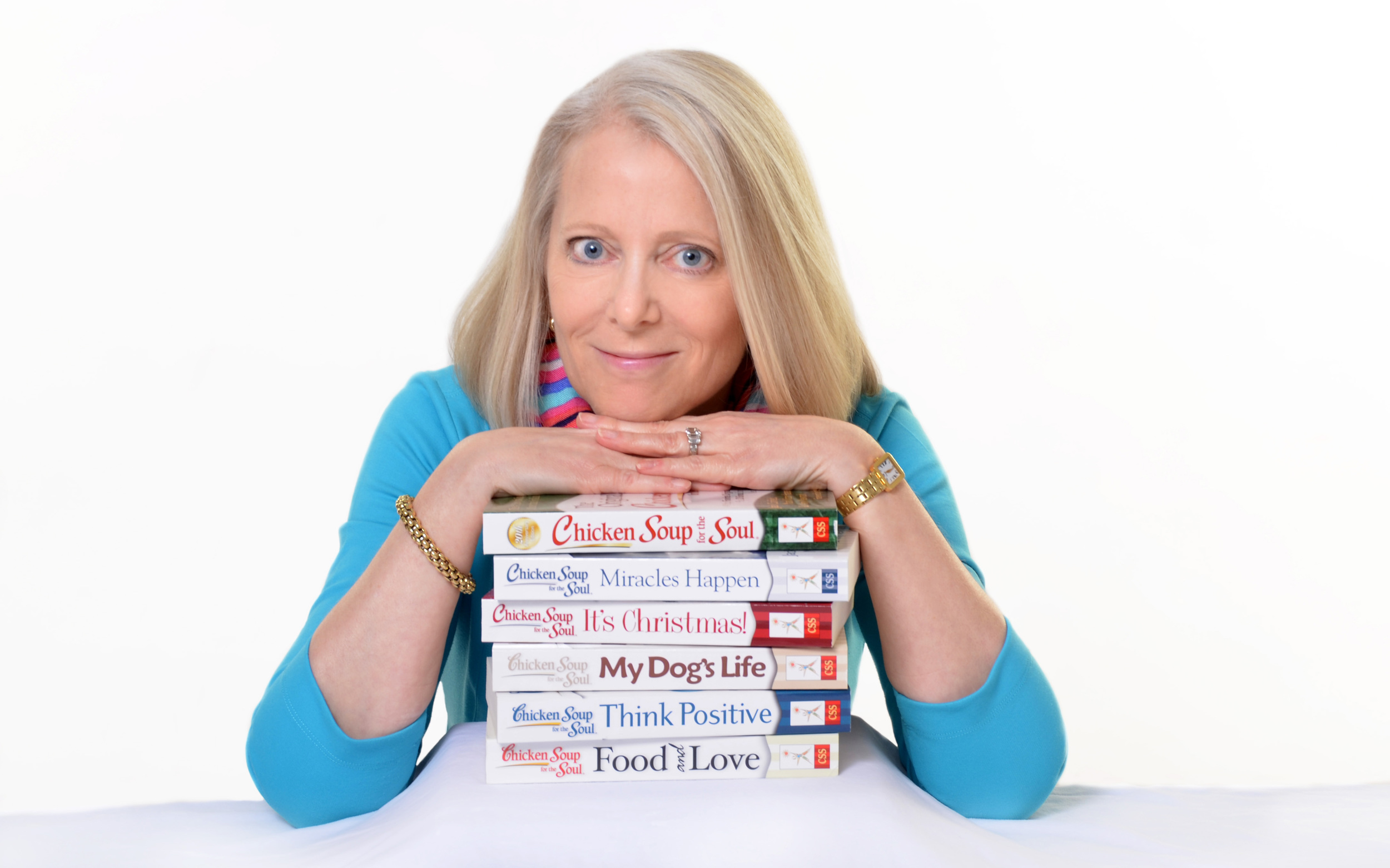 Amy Newmark leaning on stack of books_cr.jpg