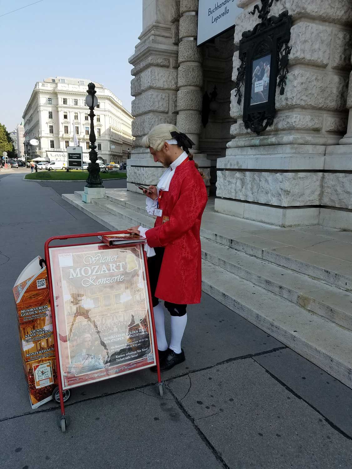 ... And Mozart sending a text message in front of Vienna's many concert halls.