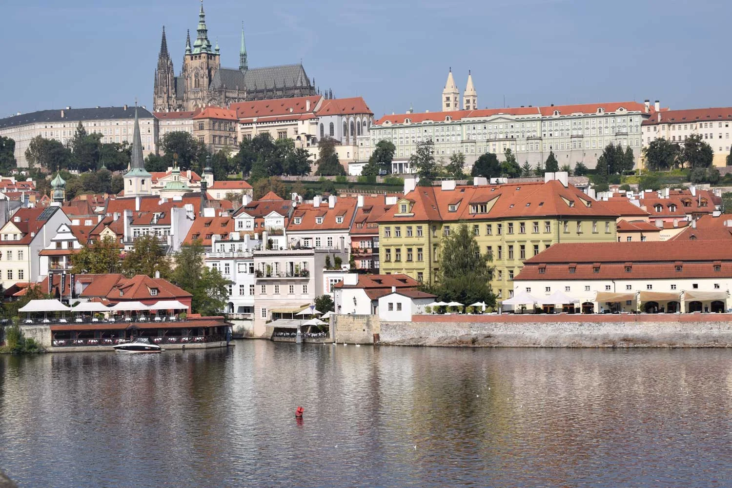 Looking up at Castle Prague from the famous Charles Bridge. That sprawling white structure is the castle; the big cathedral at the top is part of the castle complex too.