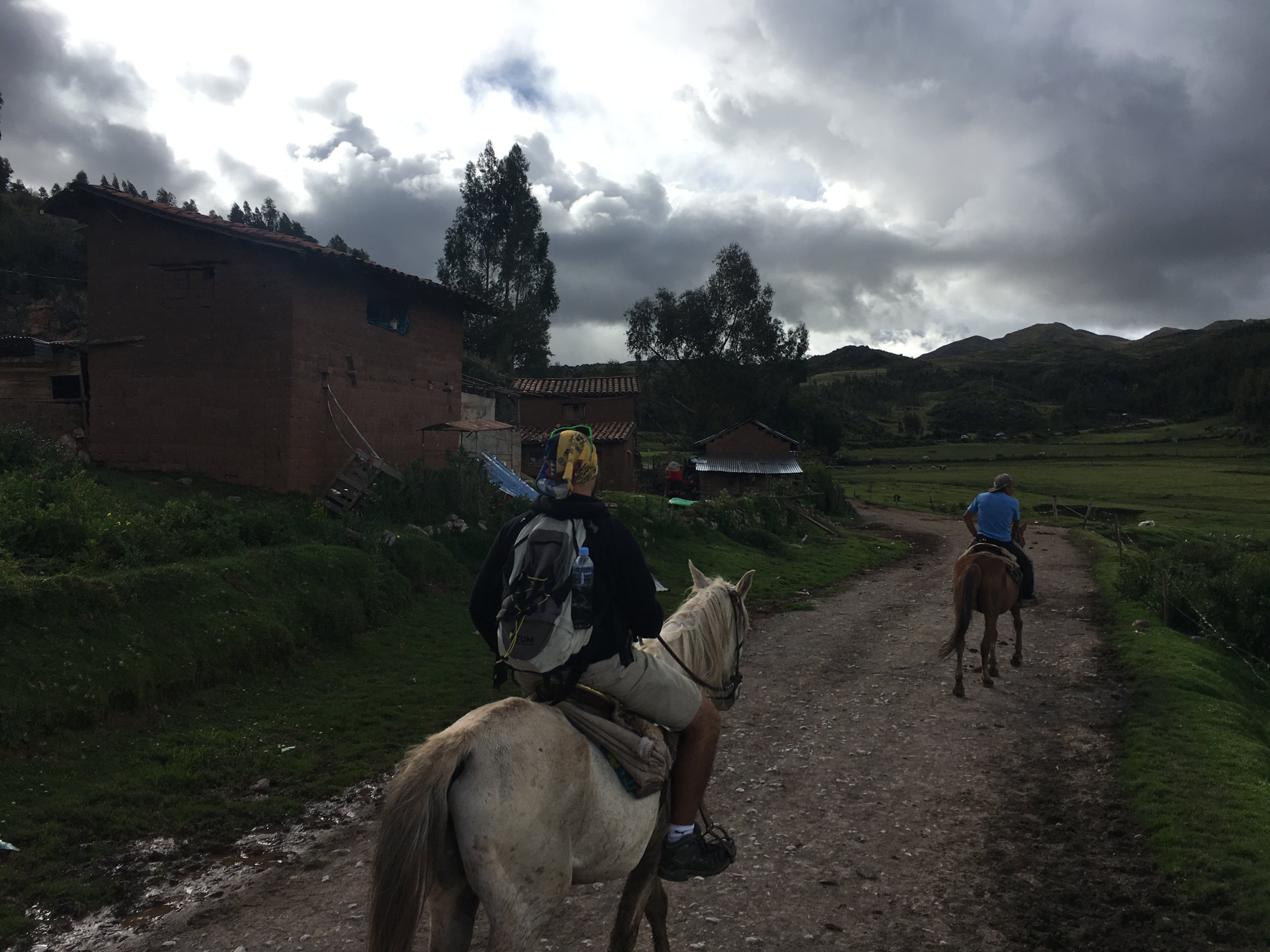 Riding horses up to the Sacsaywaman ruin. Clouds rolled in and it sprinkled for a few minutes before it cleared out.