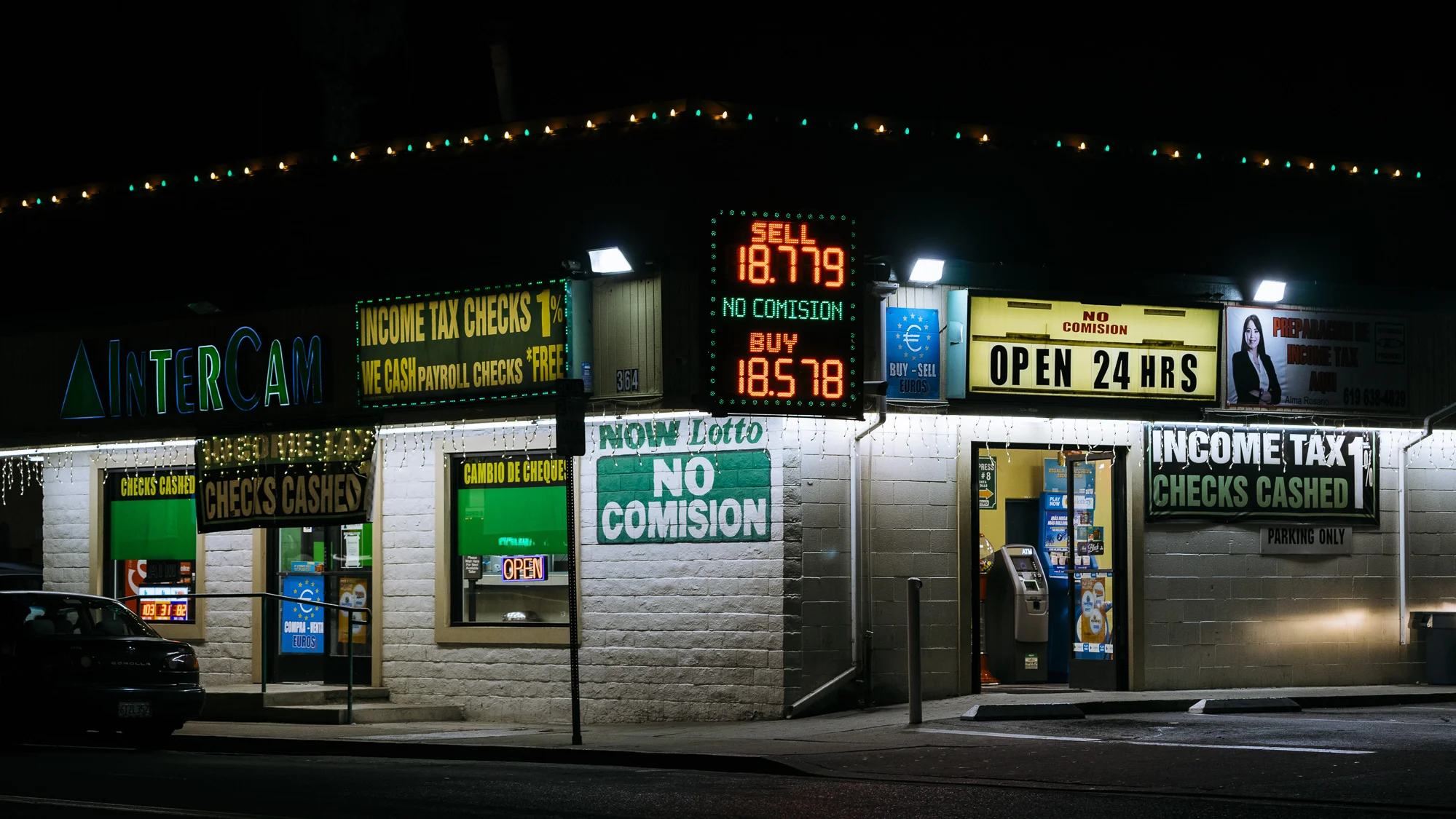IMAGE CAPTION: 24 hour currency exchange and predatory financial services are available within walking distance of the San Ysidro Port of Entry.