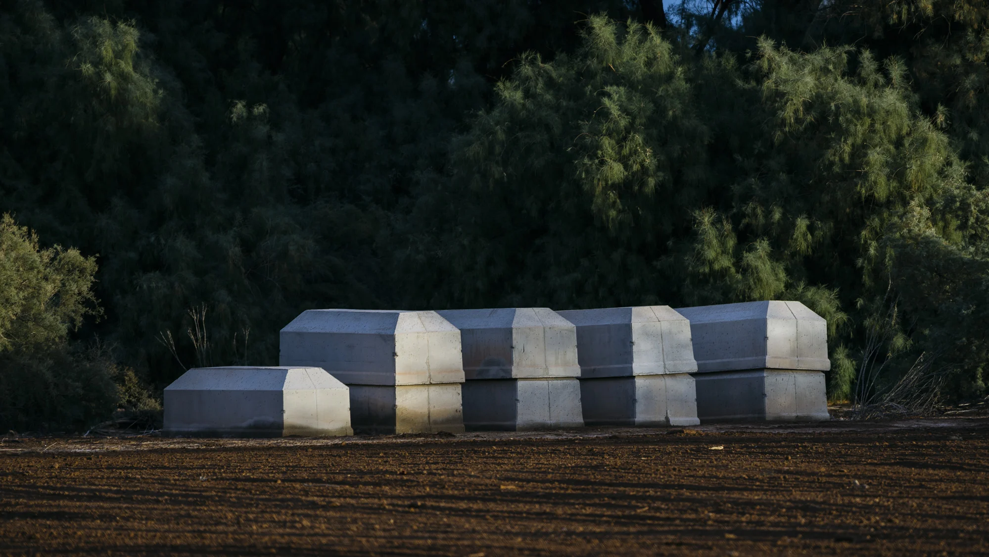 IMAGE CAPTION: Cement burial caskets await migrants whose remains are not repatriated to their home countries in Holtville, California.